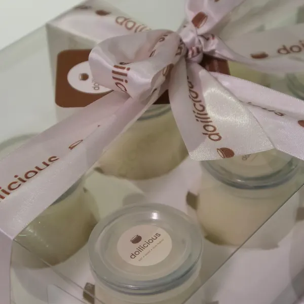 Jars of doi in a clear gift box tied with a Doilicious satin ribbon